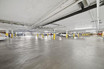 Los Angeles apartment for rent - A spacious parking garage with concrete floors and multiple levels.