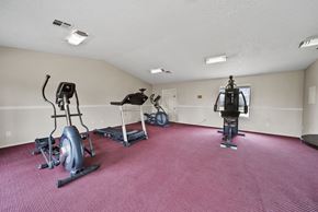 Avenal apartment for rent - A room with a red carpet and exercise equipment.