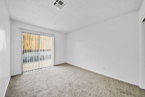 Desert Hot Springs apartment for rent - A room with a carpeted floor and a window with blinds.