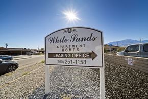 Desert Hot Springs apartment for rent - A sign for White Pands Apartment Homes with a phone number for the leasing office.