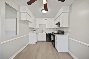 Lancaster apartment for rent - A kitchen with white cabinets and a black stove top oven.