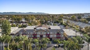 Canoga Park apartment for rent - A residential area with apartment buildings and palm trees.