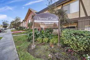 Van Nuys apartment for rent - A sign for Diamond Head Apartment Homes stands in front of a building.