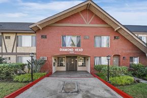 Van Nuys apartment for rent - The front of a red brick building with the words "Diamond Head" on it.