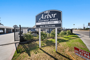 San Bernardino apartment for rent - A sign for Arbor Apartment Homes is displayed in front of a fence.