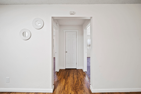 San Bernardino apartment for rent - A white door is in a white room with a light switch on the wall.