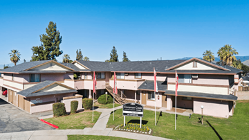 Redlands apartment for rent - A building with a sign in front of it.