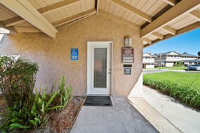 Redlands apartment for rent - A building entrance with a ramp and a sign indicating it is handicap accessible.