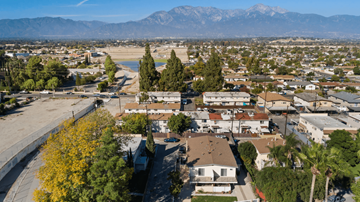 Ontario apartment for rent - A residential area with houses and trees in the foreground and mountains in the background.