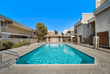 Fontana apartment for rent - A swimming pool in a residential area surrounded by houses.