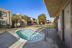Fontana apartment for rent - A small pool in a courtyard surrounded by buildings.