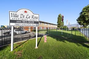 Highland apartment for rent - A sign for Villa De La Rosa Apartment Homes stands in front of a building.