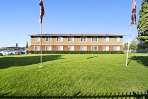 Highland apartment for rent - A hotel with a red flag on the left and a white flag on the right.