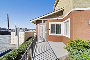 Highland apartment for rent - A house with a brown wall and a white door is shown.