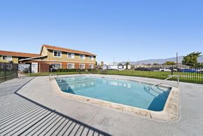 Highland apartment for rent - A small pool in a concrete area with a building in the background.