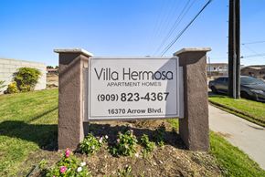 Fontana apartment for rent - A sign for Villa Hermosa Apartment Homes with a phone number and address.