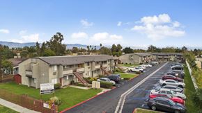 Fontana apartment for rent - A parking lot with cars and a sign that says Windous.