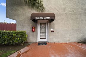 Fontana apartment for rent - A leasing center with a white door and a red fire extinguisher on the wall.