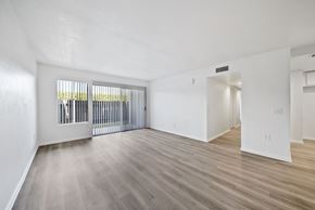 Rialto apartment for rent - A spacious room with a sliding door and hardwood flooring.