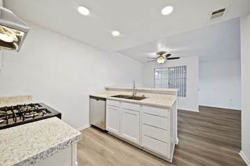 Rialto apartment for rent - A kitchen with a black gas stove and white cabinets.