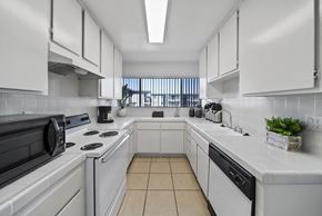 Rowland Heights apartment for rent - A kitchen with white cabinets and appliances.