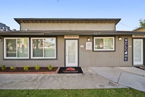 Riverside apartment for rent - The front of a building with a leasing office and media room.