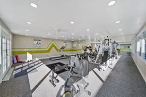 Stanton apartment for rent - A gym with a variety of equipment including treadmills, weights, and exercise machines.