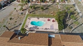 Bullhead City apartment for rent - A swimming pool with a heart design in the middle of a backyard.