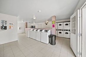 Bullhead City apartment for rent - A kitchen with white appliances and a trash can.