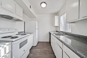 Las Vegas apartment for rent - A modern kitchen with white appliances and cabinets.