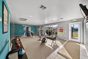 Las Vegas apartment for rent - A gym with a variety of equipment including a treadmill, weights, and a bench press.