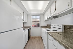 Las Vegas apartment for rent - A kitchen with white appliances and wooden floors.