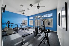 Las Vegas apartment for rent - A gym with a variety of equipment including treadmills, weights, and a bench press.