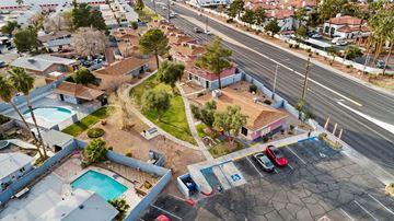 Las Vegas apartment for rent - A parking lot with cars and a pool in the foreground.