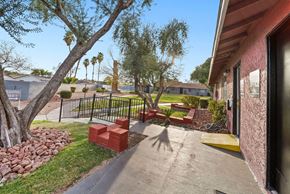 Las Vegas apartment for rent - A red brick bench sits in the middle of a concrete walkway.