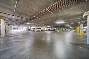 Panorama City apartment for rent - A spacious parking garage with multiple cars parked.