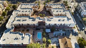Panorama City apartment for rent - An aerial view of a building with a pool in the middle.