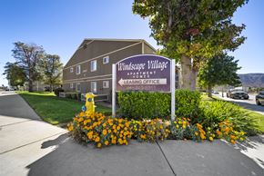 Banning apartment for rent - A sign for Windsafe Village Apartment is in front of a building.