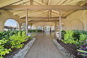 Fullerton apartment for rent - A long wooden walkway leads through a landscaped garden.