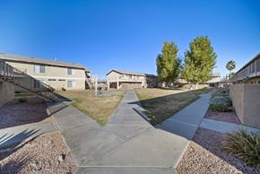 Hesperia apartment for rent - A sunny day in a residential area with houses and trees.