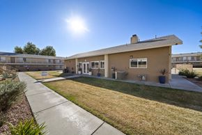 Hesperia apartment for rent - A sunny day at a residential complex with a clear blue sky.