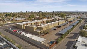 Phoenix apartment for rent - A parking lot with cars and a building in the background.
