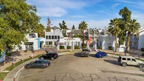 Phoenix apartment for rent - A parking lot with cars and a building in the background.