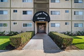 Hawthorne apartment for rent - The front of a building with a sign that says "Village Police Apartments 13300".