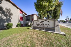 San Bernardino apartment for rent - A sign for Casa Del Sol Apartments stands in front of a building.