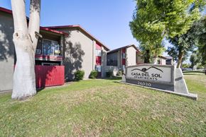 San Bernardino apartment for rent - A sign for Casa Del Sol Apartments stands in front of a building.