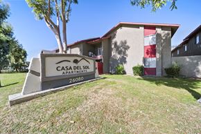 San Bernardino apartment for rent - A sign for Casa Del Sol Apartments stands in front of a building.