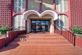 Hawthorne apartment for rent - A red brick walkway leads to a building entrance.