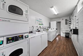 Hawthorne apartment for rent - A laundry room with washing machines and a dryer.