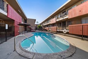 Hawthorne apartment for rent - A small pool in a courtyard surrounded by a black fence.